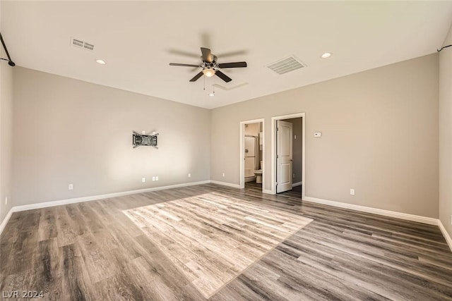 unfurnished bedroom with ceiling fan, connected bathroom, and dark hardwood / wood-style floors