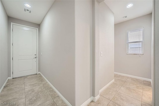 corridor with light tile patterned flooring