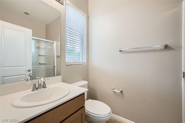 bathroom with vanity, toilet, and walk in shower