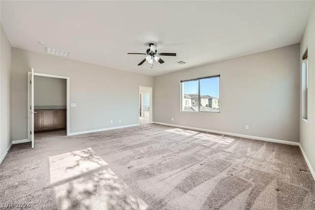 unfurnished bedroom with light carpet and ceiling fan