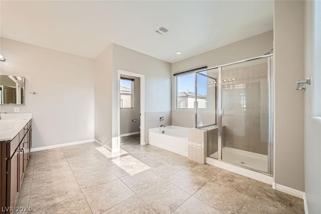 bathroom featuring independent shower and bath, vanity, and tile patterned flooring