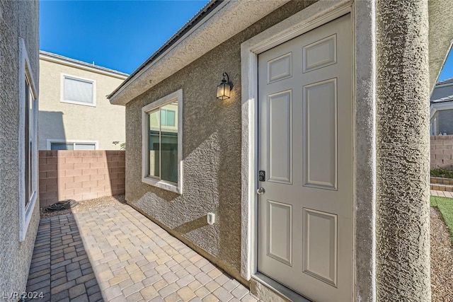 property entrance featuring a patio area