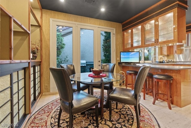 dining area featuring wood walls and sink