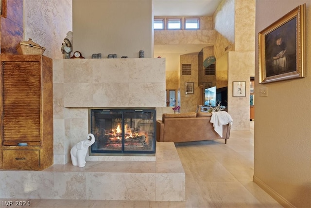 living room featuring a tiled fireplace