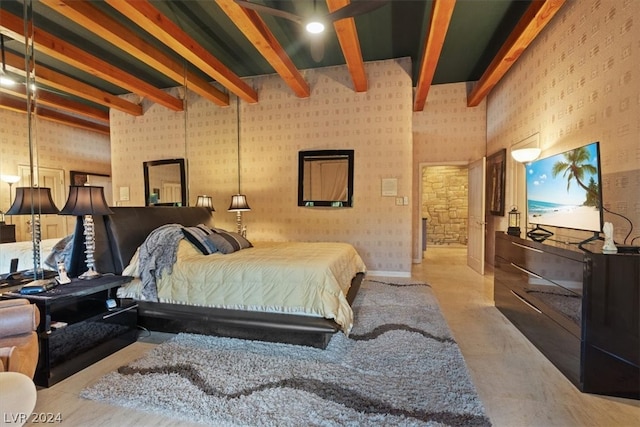 bedroom with concrete flooring, beam ceiling, and brick wall