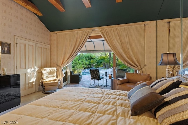 bedroom with beamed ceiling, access to outside, and high vaulted ceiling