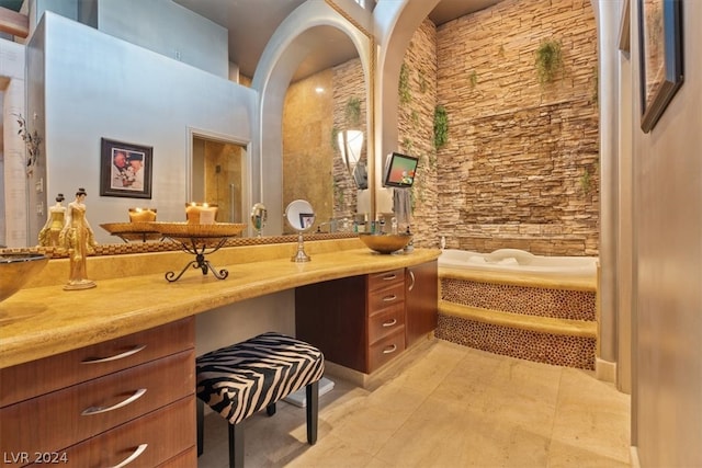 bathroom featuring a towering ceiling, vanity, and tile patterned floors