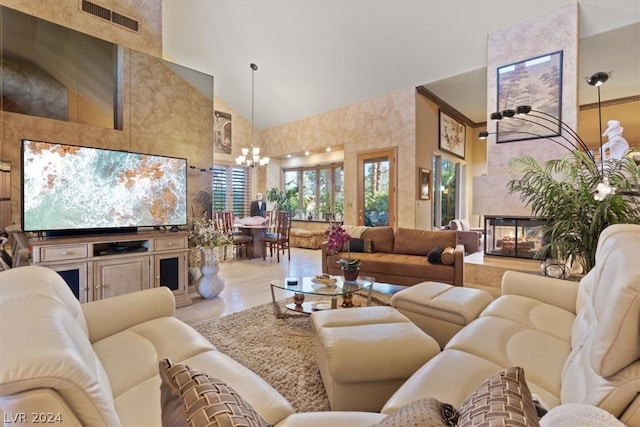 tiled living room featuring a notable chandelier, a multi sided fireplace, and high vaulted ceiling