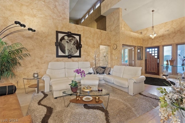 tiled living room featuring a towering ceiling