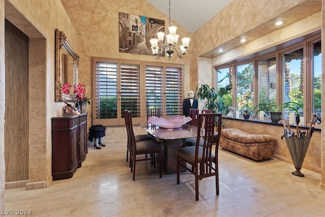 dining space featuring high vaulted ceiling and an inviting chandelier