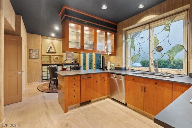 kitchen with kitchen peninsula, stainless steel dishwasher, and sink