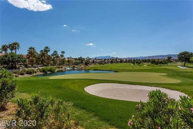 view of property's community featuring a water view and a lawn