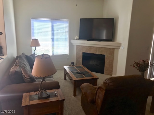 living room with carpet flooring and a tiled fireplace