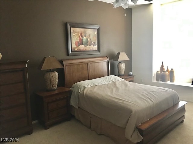 bedroom with light carpet and ceiling fan