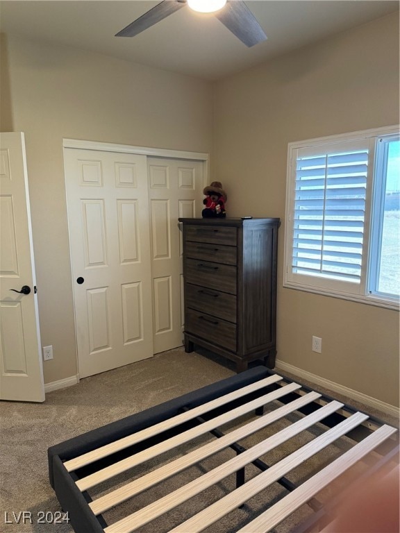 unfurnished bedroom featuring ceiling fan, carpet, and a closet