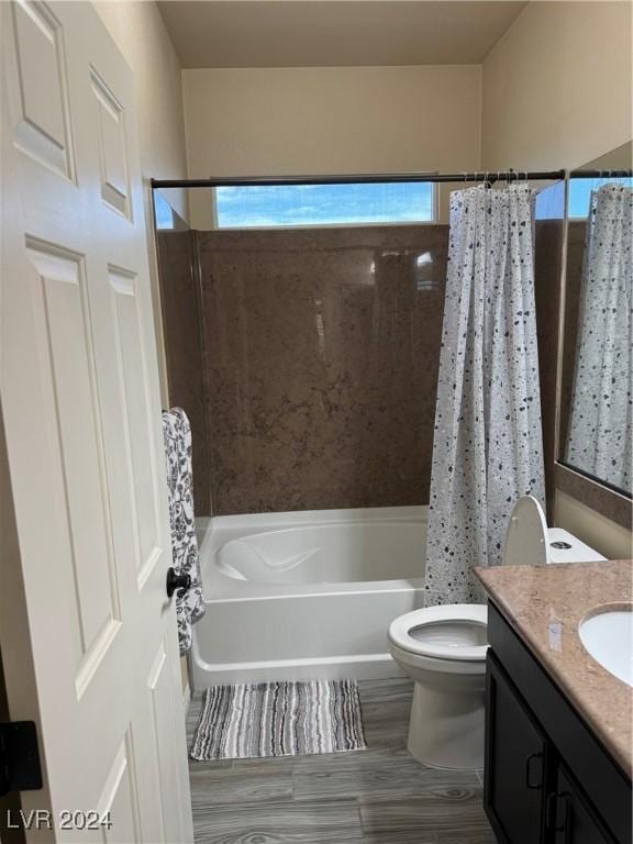 bathroom with vanity, toilet, and shower / bath combo with shower curtain