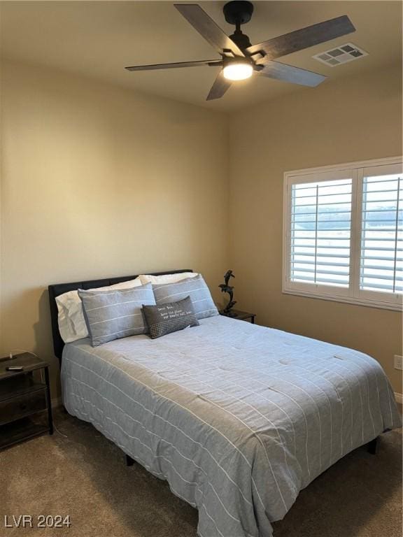 bedroom featuring carpet floors, visible vents, and ceiling fan