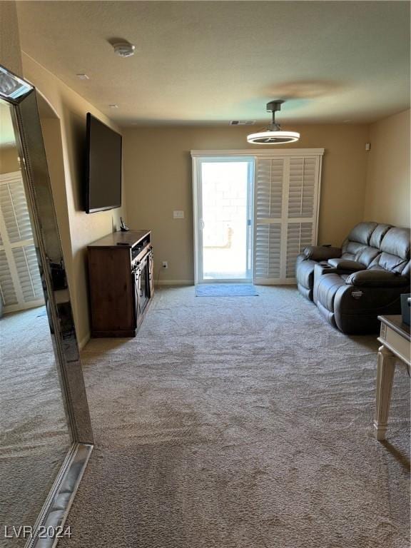 living room featuring light carpet, baseboards, and visible vents