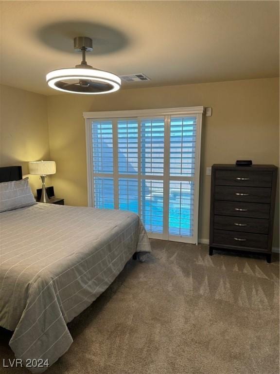 carpeted bedroom featuring ceiling fan and visible vents