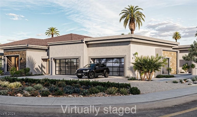 view of front of house with a garage and stucco siding