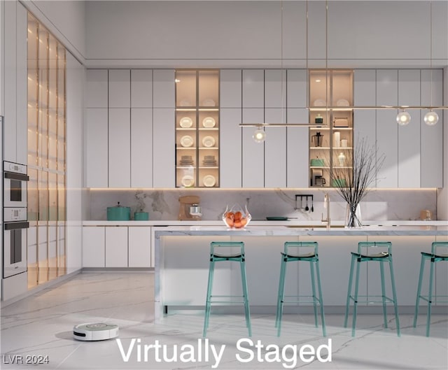 kitchen featuring white cabinets, white double oven, decorative backsplash, and modern cabinets