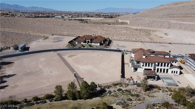 birds eye view of property featuring view of desert and a mountain view