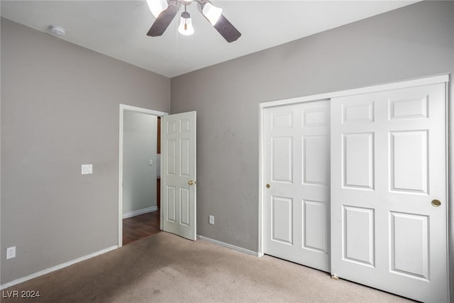 unfurnished bedroom with light colored carpet, ceiling fan, and a closet