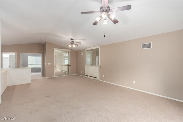 carpeted empty room with vaulted ceiling and ceiling fan