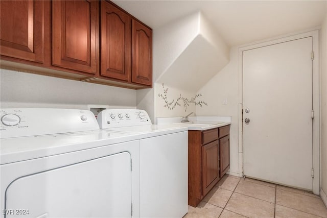 laundry room featuring cabinets, separate washer and dryer, sink, and light tile patterned floors