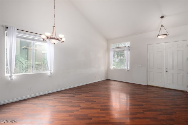 interior space with a notable chandelier, vaulted ceiling, and hardwood / wood-style floors