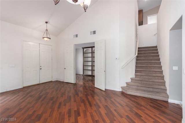 interior space with dark hardwood / wood-style floors and high vaulted ceiling