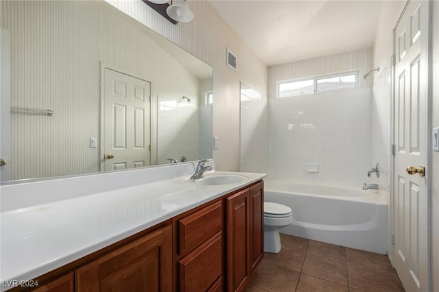 full bathroom featuring tiled shower / bath combo, vanity, tile patterned floors, and toilet