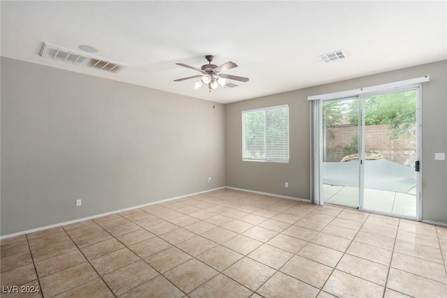 spare room featuring light tile patterned flooring and ceiling fan