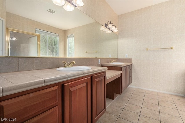 bathroom featuring a notable chandelier, vanity, and tile patterned floors