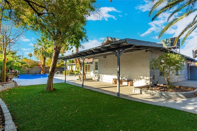 rear view of house with a patio area and a yard