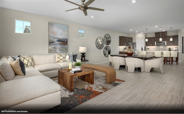 living room featuring light tile patterned flooring and ceiling fan