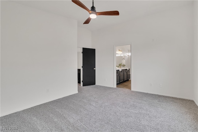 carpeted spare room with ceiling fan