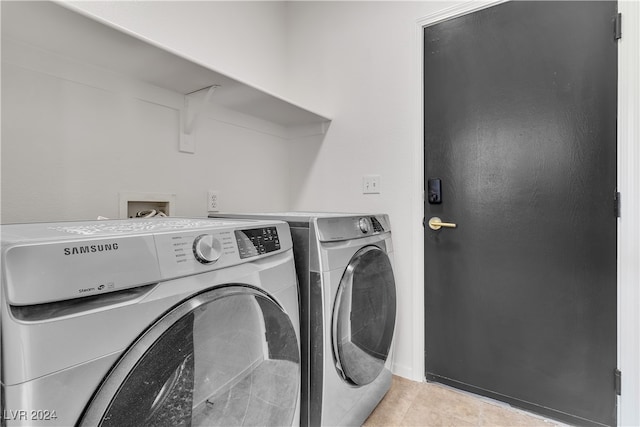 laundry area with separate washer and dryer and light tile patterned floors