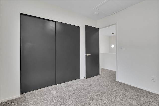 unfurnished bedroom featuring carpet floors and a closet