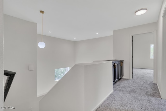 hallway with light colored carpet