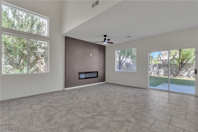 unfurnished living room with ceiling fan