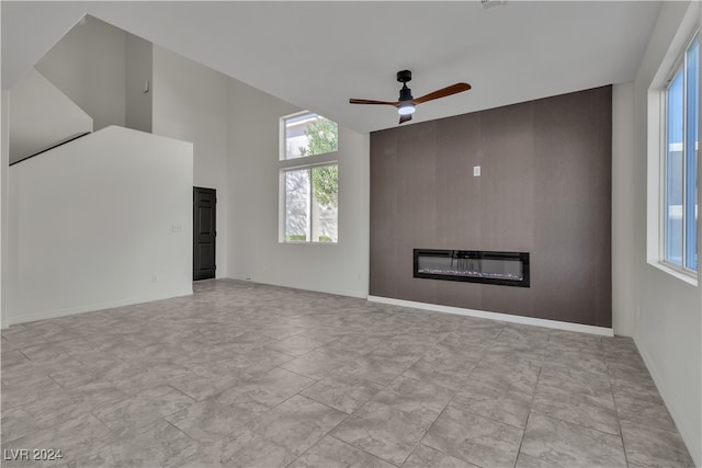 unfurnished living room featuring ceiling fan