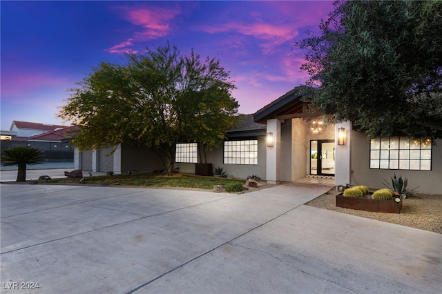 view of front of home featuring concrete driveway and stucco siding