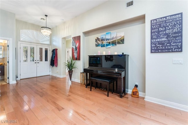 foyer featuring hardwood / wood-style floors and an inviting chandelier