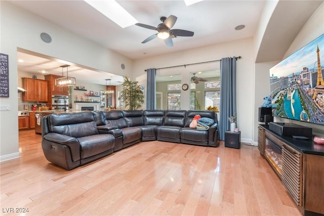 living room featuring ceiling fan and light hardwood / wood-style flooring