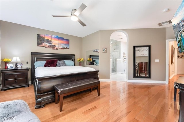 bedroom with ceiling fan, ensuite bath, and light hardwood / wood-style flooring