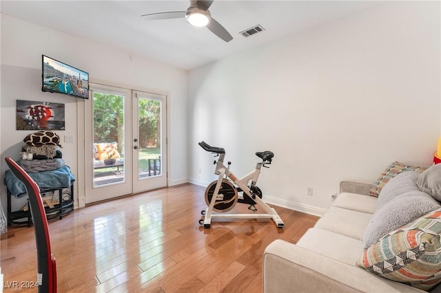 workout area featuring french doors, ceiling fan, and light hardwood / wood-style floors