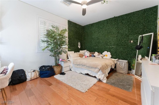 bedroom featuring hardwood / wood-style flooring and ceiling fan