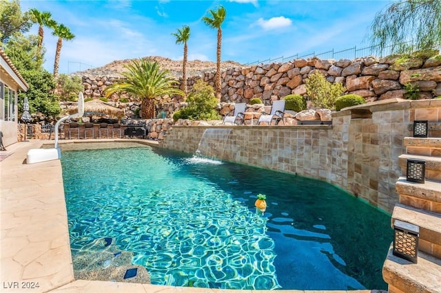 view of swimming pool featuring pool water feature