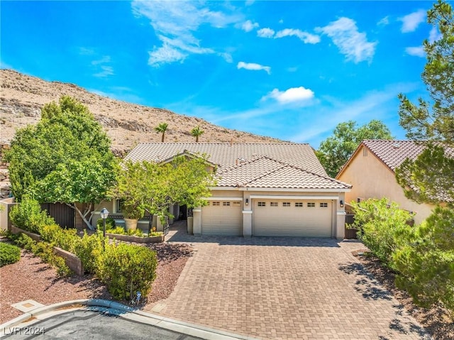 view of front of property featuring a garage and a mountain view